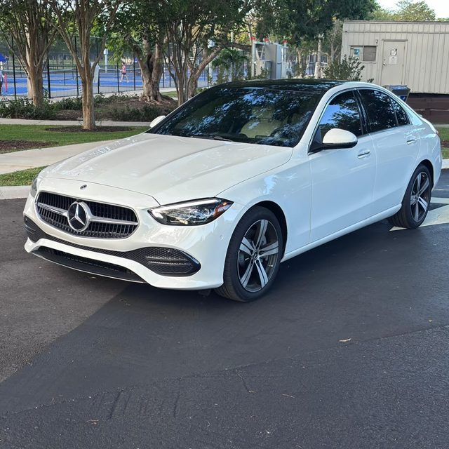 White Mercedes-Benz C300, front three-quarter left side