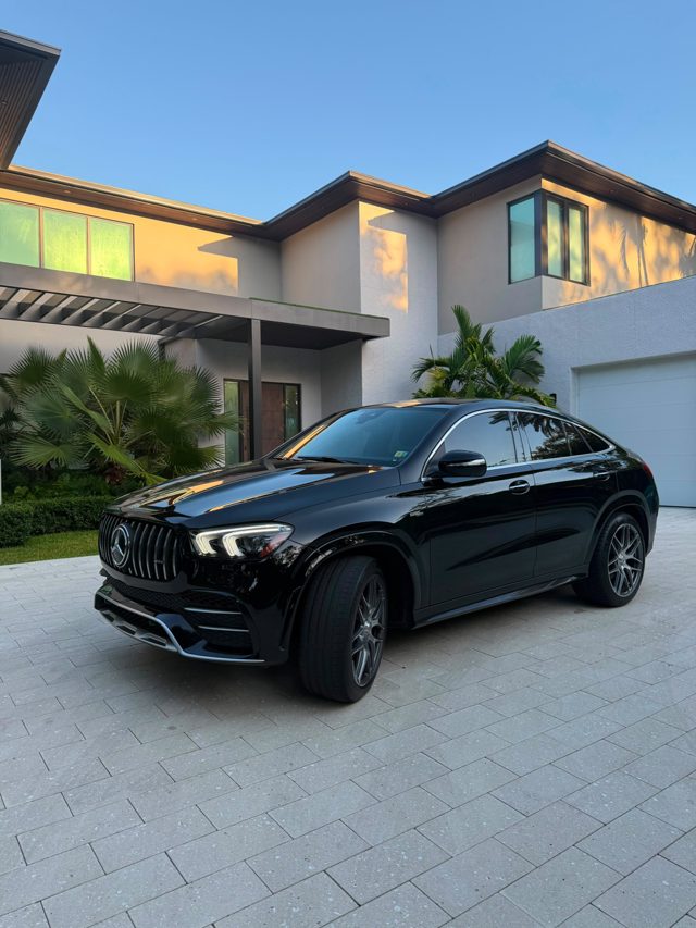 Black Mercedes-AMG GLE 53 Coupe in front of a modern house