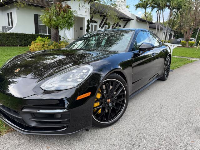 Black Porsche Panamera, front three-quarter view with yellow calipers